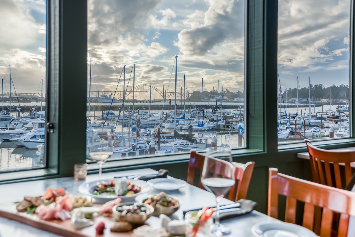 A scenic restaurant overlooking boats docked in the harbor, offering a picturesque dining experience by the water.